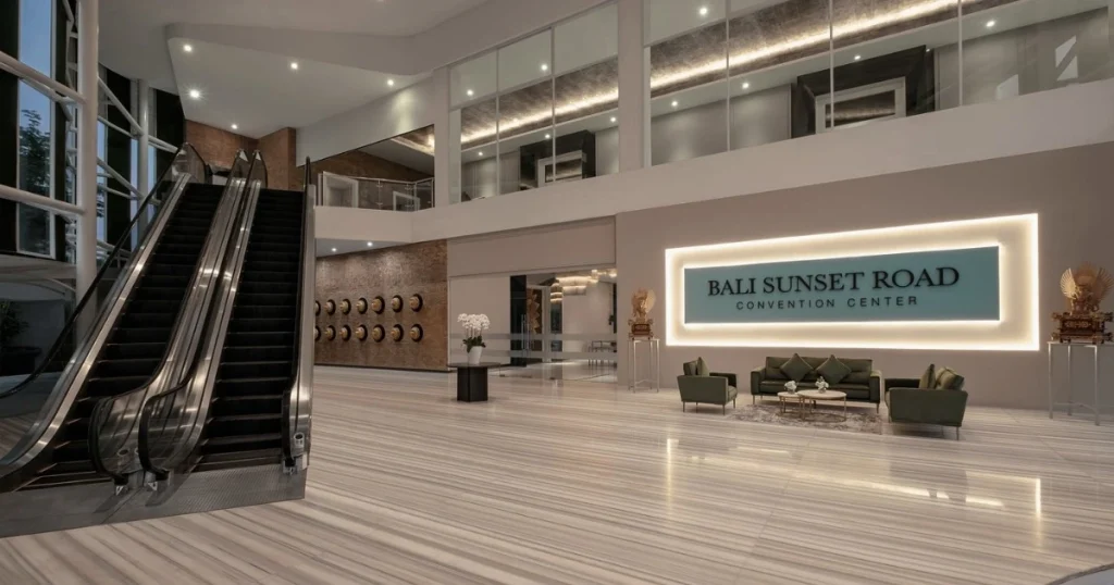 Lobi Bali Sunset Road Convention Center dengan eskalator, ruang tunggu, dan area luas untuk menyambut peserta seminar atau rapat.